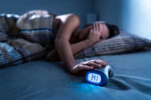 Person in bed unable to sleep due to restless leg syndrome in Walnut Creek, CA